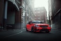 Red car stay on asphalt road in the city at daytime Royalty Free Stock Photo