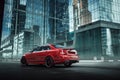 Red car stay on asphalt road in the city at daytime Royalty Free Stock Photo