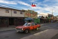 A red car in a street of the town of Coyhaique in Chile, South America