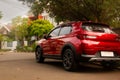 A red car or SUV parked on the side of the road and in front of the house Royalty Free Stock Photo