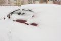 Red car under a large snowdrift, snow storm, winter, blizzard, storm warning, drift Royalty Free Stock Photo