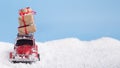 Red car Volkswagen Beetle with present boxes on snow background Royalty Free Stock Photo