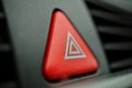 Red car Warning button with a white triangle switching all the vehicle outdoor indicators as a symbol of caution, warning and po Royalty Free Stock Photo