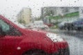 The red car through wet glass. Royalty Free Stock Photo