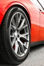 Red car. Car wheels close up on a background of asphalt. Car tires. Car wheel close-up. for advertising Royalty Free Stock Photo