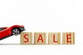 red car on a white background and wooden cubes with the inscription sale, car sale concept Royalty Free Stock Photo