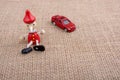 Red car and wooden Pinocchio doll Royalty Free Stock Photo