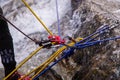 Red carabiner, climbing rope and equipment on the rock and stream