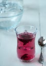 Red carcade tea in transparent glass cup at white wooden background Royalty Free Stock Photo