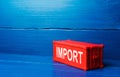 Red cargo ship container with word IMPORT. Admission of foreign goods to the national market, commercial globalization and global