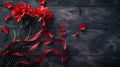 Red carnations and ribbon on a wooden background Royalty Free Stock Photo