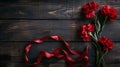 Red carnations and ribbon on a wooden background Royalty Free Stock Photo