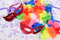 red carnival costume mask with colorful confetti and streamers joyful brazilian party celebration on white background with space Royalty Free Stock Photo