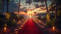 Red carpet on the beach with palm trees at sunset Royalty Free Stock Photo
