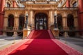 red carpet leading to the entrance of a grand building, such as a palace or cathedral