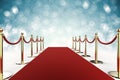 Red carpet with rope barrier on blue background