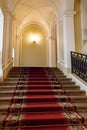 Red carpet on the staircase in luxury interior Royalty Free Stock Photo