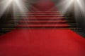 Red carpet on the stairs on a dark background. The path to glory, victory and success Royalty Free Stock Photo