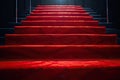 Red carpet on the stairs on a dark background. The path to glory, victory and success Royalty Free Stock Photo