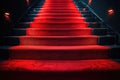 Red carpet on the stairs on a dark background. The path to glory, victory and success Royalty Free Stock Photo