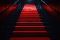 Red carpet on the stairs on a dark background. The path to glory, victory and success Royalty Free Stock Photo