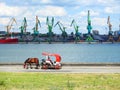 Red carriage , horse and Klaipeda port, Lithuania Royalty Free Stock Photo