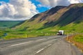 Red cars running on the hill roads in rural Iceland roads