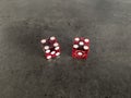 Red casino dice cubes on black backround