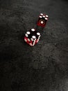 Red casino dice cubes on black backround