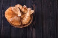 Red cat washes, sitting in a basket on a wooden background, studio Royalty Free Stock Photo