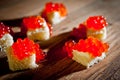 Red caviar with bread and butter on a dark background