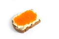 Red caviar and butter smeared on a piece of black bread Royalty Free Stock Photo