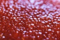 Red caviar close-up macro texture, salted red caviar on a seafood production, packaging and distribution company, producing