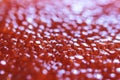 Red caviar close-up macro texture, salted red caviar on a seafood production, packaging and distribution company, producing