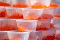 Red caviar in containers in the market