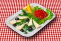 Red caviar with Fetta cheese, lemon, black olives and vegetables