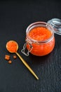 Red caviar in the glass jar on black slate background Royalty Free Stock Photo