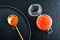 Red caviar in the glass jar on black slate background Royalty Free Stock Photo