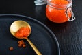 Red caviar in the glass jar on black slate background Royalty Free Stock Photo