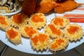 Red caviar and grated cheese in small dough baskets. A delicious cold appetizer with seafood