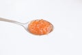 Red caviar on a metal spoon close-up. Concept for Christmas and New Year festive dishes. Healthy natural red salmon