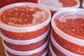 Red caviar plactic jars, rows of salted canned red caviar containers filled to the top on a seafood production, packaging and