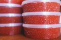 Red caviar plactic jars, rows of salted canned red caviar containers filled to the top on a seafood production, packaging and