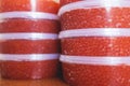 Red caviar plactic jars, rows of salted canned red caviar containers filled to the top on a seafood production, packaging and