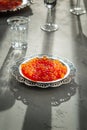 Red caviar on silver plate with vodka shot Royalty Free Stock Photo