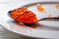 Red caviar in the silver spoon in front of white background Royalty Free Stock Photo