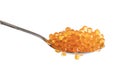 Red caviar in the silver spoon isolated on a white background. Trout or salmon caviar close up. Macro shot.