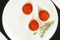 Red caviar in small bowls on white background. top view.