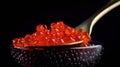 Red Caviar in a spoon. Caviar in bowl over black background. Close-up salmon caviar, isolated on black, generative ai. Royalty Free Stock Photo