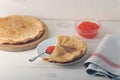 Red caviar in the spoon and pancakes in plate Royalty Free Stock Photo